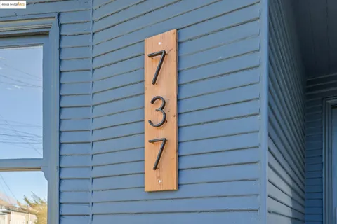 a view of a hallway with wooden floor and door