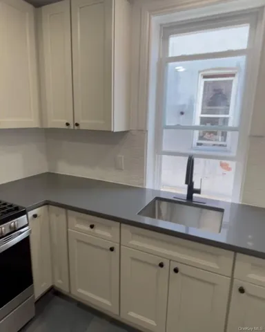 a kitchen with appliances cabinets and a sink