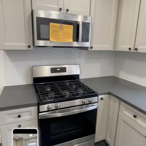 a stove top oven sitting inside of a kitchen