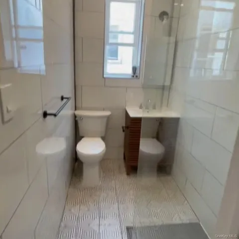 a bathroom with a toilet a sink and a mirror