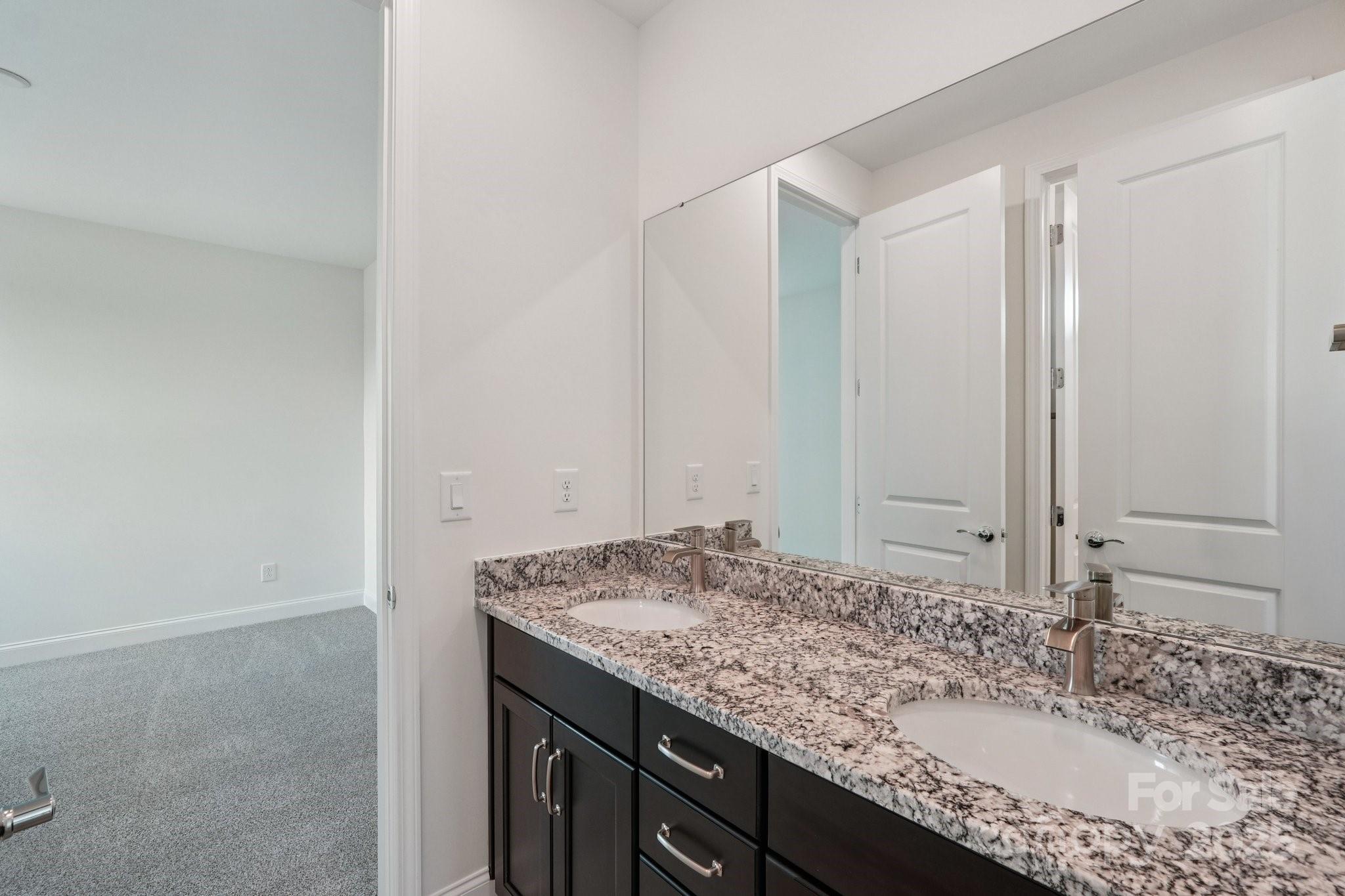 716 Flare Drive Tega Cay, SC 29708 - Photo 15 of 19 a bathroom with a granite countertop sink and a mirror