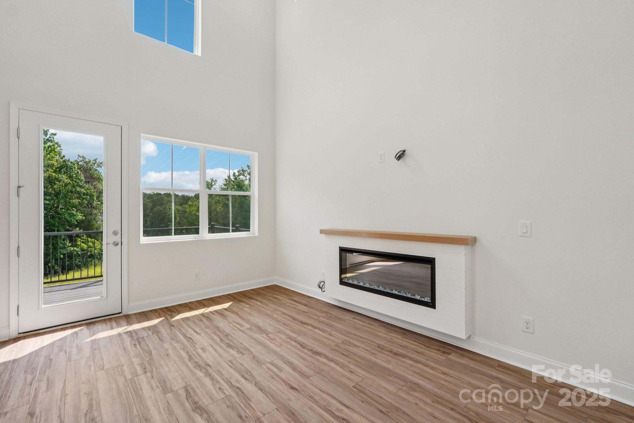 716 Flare Drive Tega Cay, SC 29708 - Photo 7 of 19 a view of an empty room with wooden floor and a window