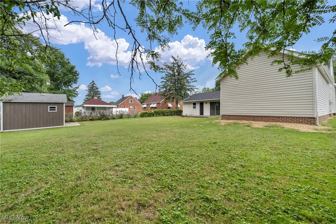 20202 Sumpter Road Cleveland, OH 44128 - Photo 46 of 46 View of green lawn featuring a storage unit