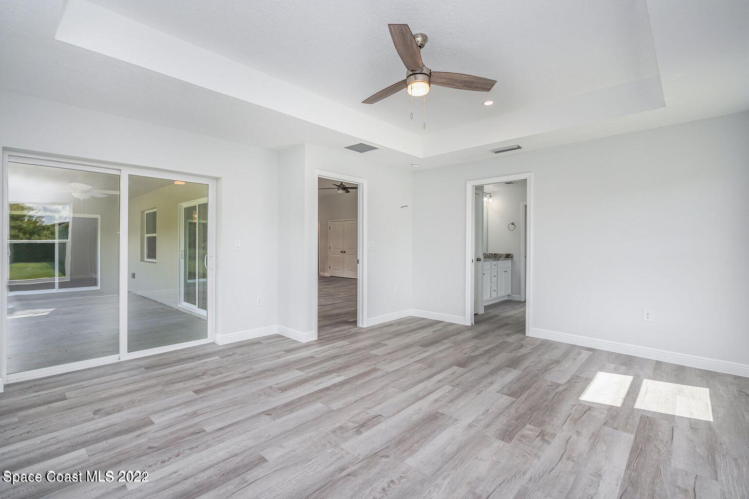 4035 Grant Line Road Mims, FL 32754 - Photo 11 of 18 a view of an empty room with wooden floor and a window