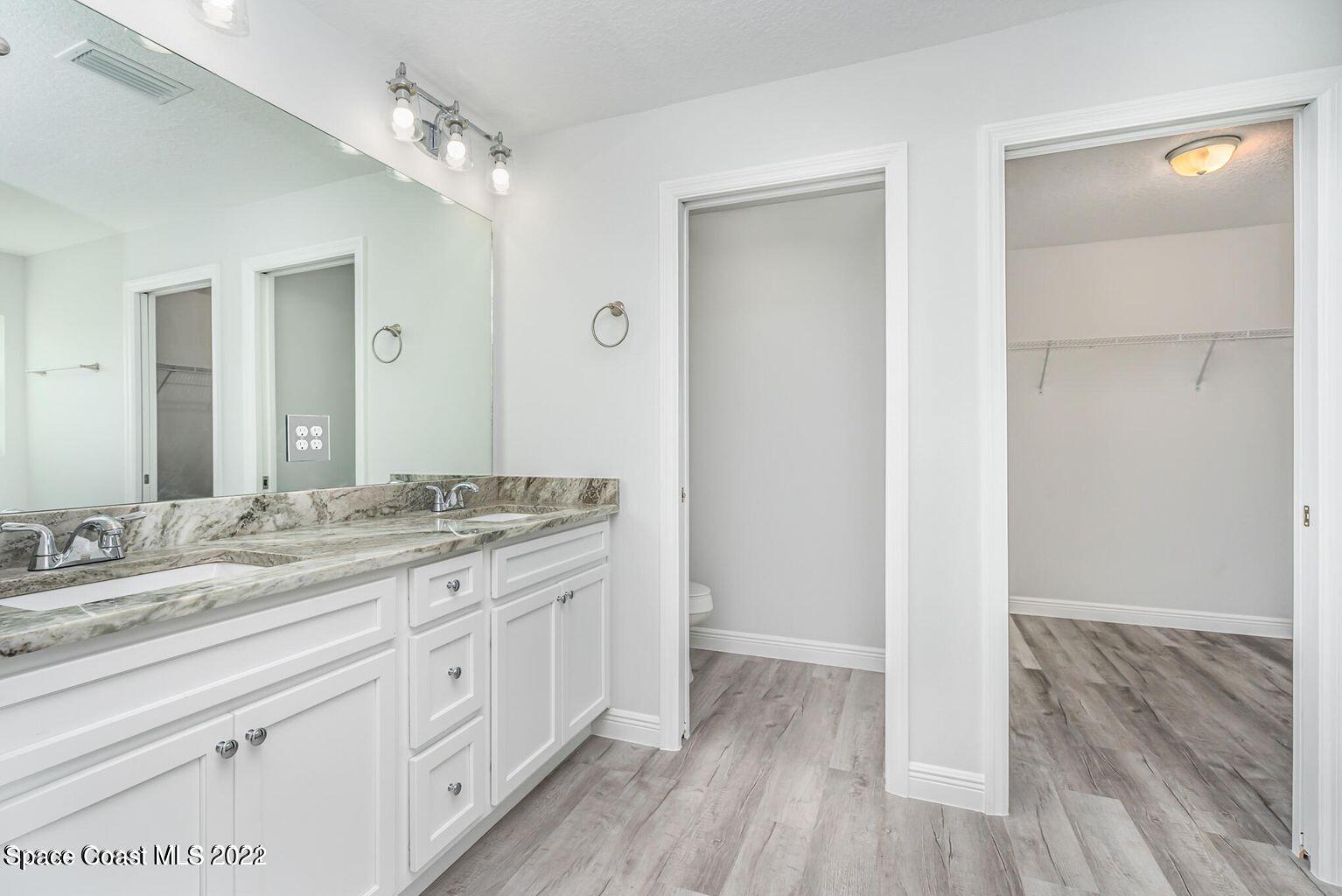 4035 Grant Line Road Mims, FL 32754 - Photo 12 of 18 a bathroom with a granite countertop double vanity sink a mirror and a shower