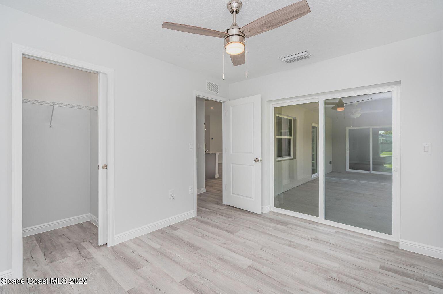 4035 Grant Line Road Mims, FL 32754 - Photo 13 of 18 a view of an empty room with wooden floor