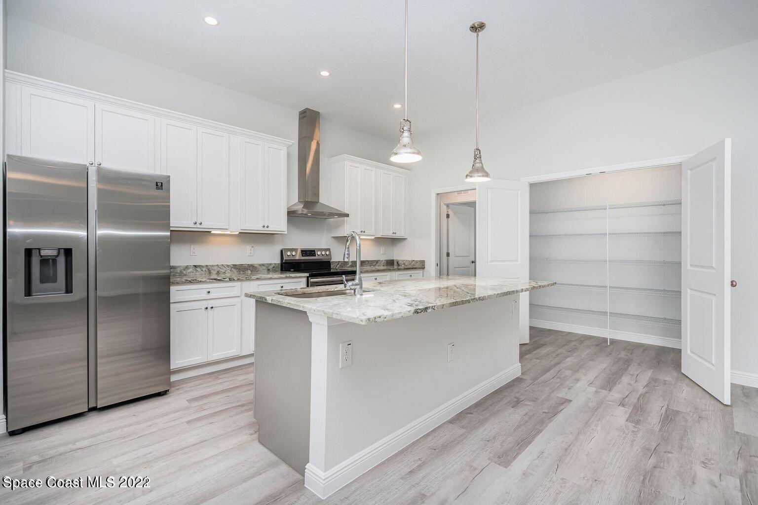 4035 Grant Line Road Mims, FL 32754 - Photo 16 of 18 a kitchen with kitchen island a counter top space a stove and refrigerator