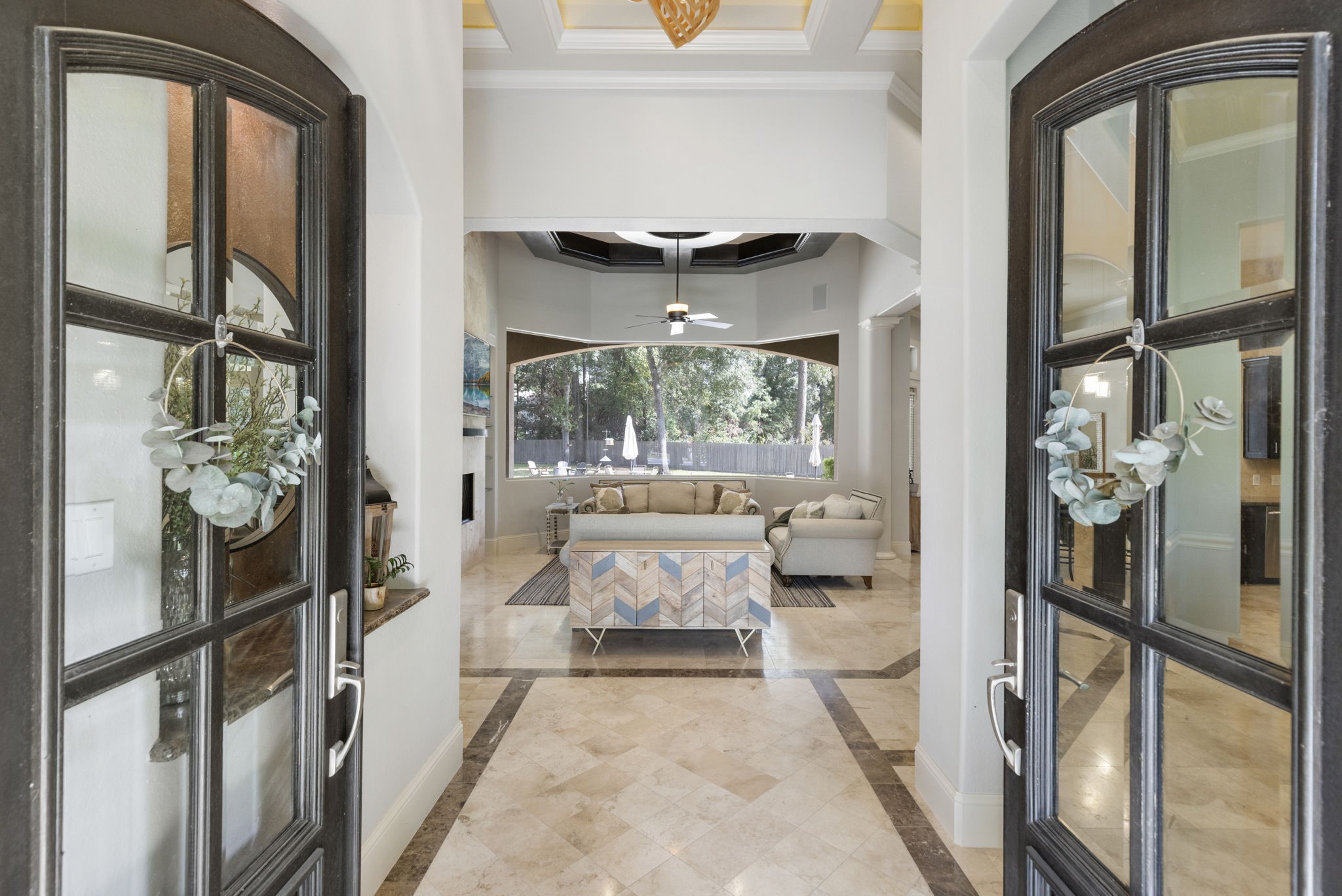 4103 Tee Tree Court Spring, TX 77386 - Photo 8 of 37 Arched double-door entry opens to travertine floors with a granite border, decorative niche, and high tray ceiling with accent lighting. Clear sightlines draw your eye straight to the backyard pool.