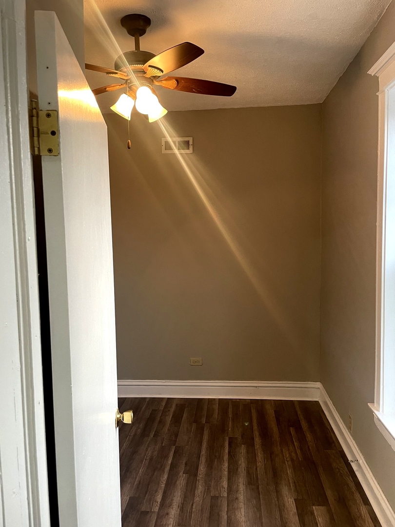 451 East 111th Street, Unit 3R Chicago, IL 60628 - Photo 4 of 6 a view of wooden floor