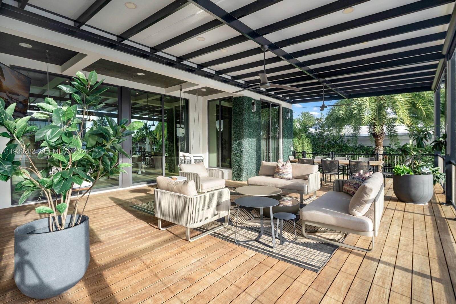 1970 Northeast 119th Road North Miami, FL 33181 - Photo 11 of 54 a outdoor living space with furniture and garden view