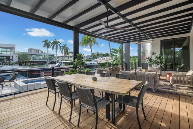a view of a dinning table and chairs in the balcony