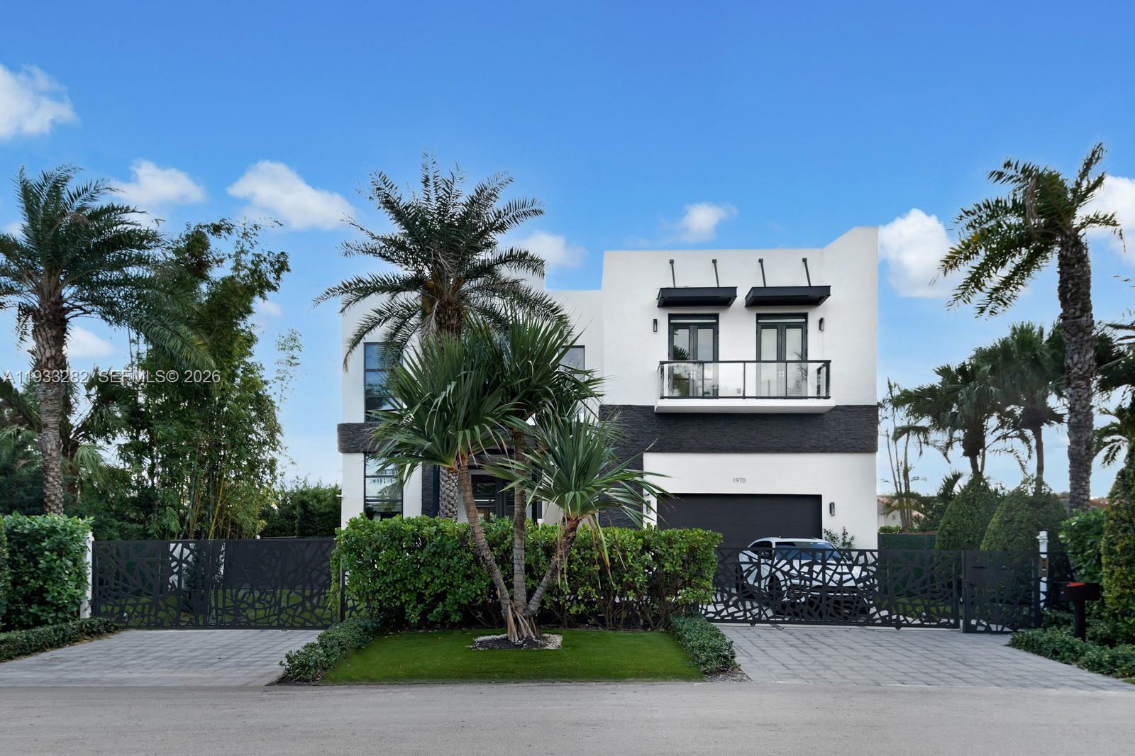 1970 Northeast 119th Road North Miami, FL 33181 - Photo 16 of 54 a front view of a house with a garden