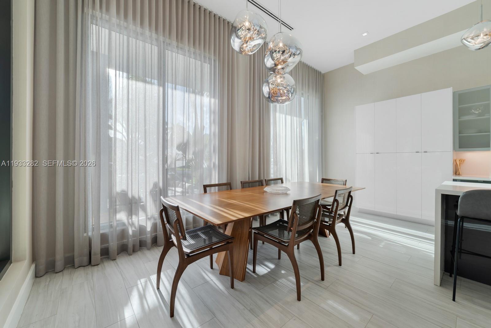 1970 Northeast 119th Road North Miami, FL 33181 - Photo 29 of 54 a view of a dining room with furniture and window