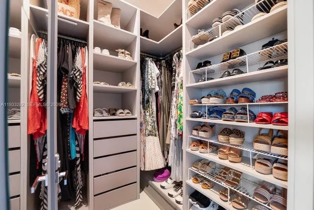 a bathroom with a tub a sink and mirror