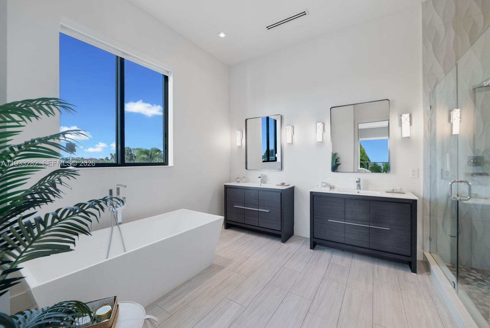 1970 Northeast 119th Road North Miami, FL 33181 - Photo 37 of 54 a bathroom with a tub a sink and mirror