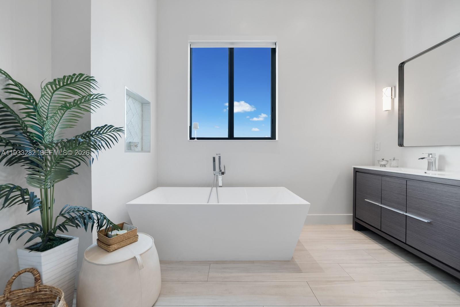 1970 Northeast 119th Road North Miami, FL 33181 - Photo 38 of 54 a white bath tub sitting in a bathroom
