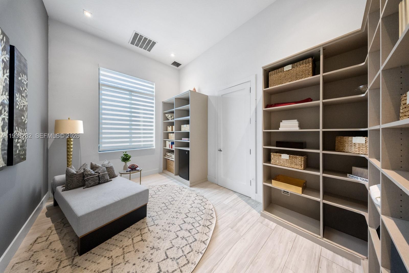 1970 Northeast 119th Road North Miami, FL 33181 - Photo 41 of 54 a bedroom with furniture and a book shelf