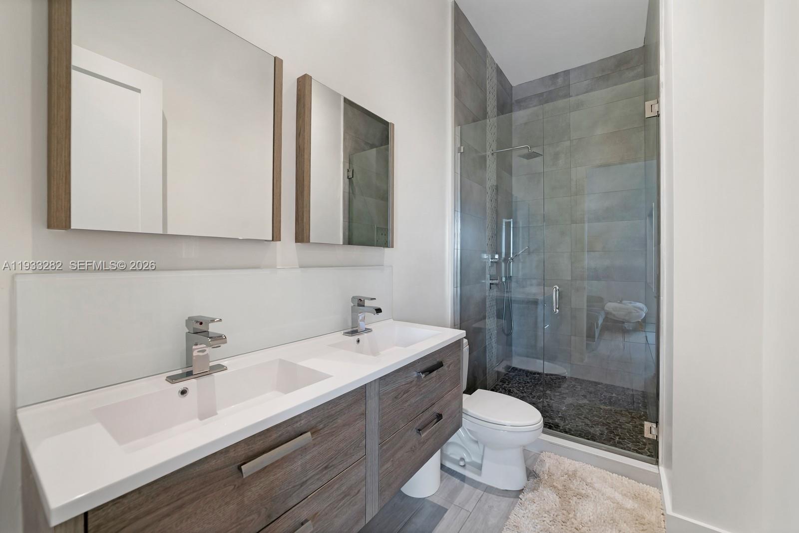 1970 Northeast 119th Road North Miami, FL 33181 - Photo 49 of 54 a bathroom with a sink a toilet and shower