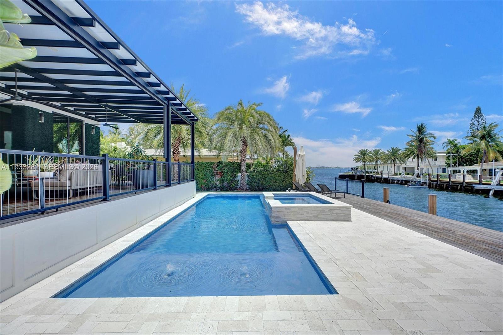1970 Northeast 119th Road North Miami, FL 33181 - Photo 7 of 54 a view of a swimming pool with a patio
