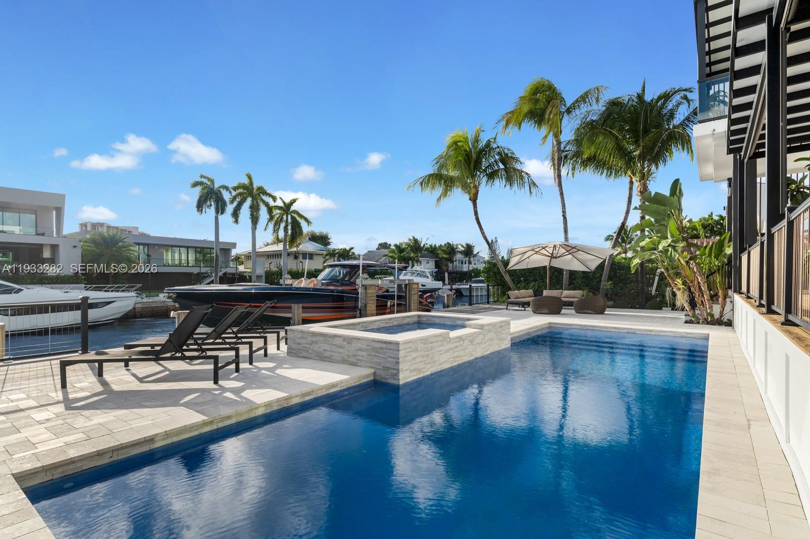 1970 Northeast 119th Road North Miami, FL 33181 - Photo 7 of 54 a view of a swimming pool with chairs