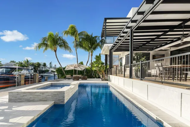 a swimming pool with outdoor seating and yard