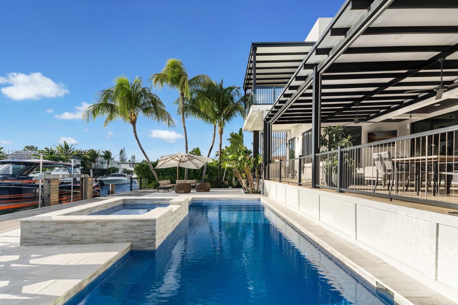 1970 Northeast 119th Road North Miami, FL 33181 - Photo 8 of 54 a swimming pool with outdoor seating and yard