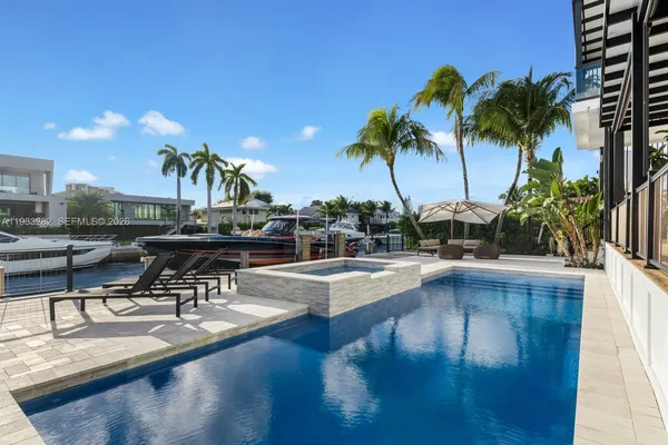 a view of a swimming pool with chairs
