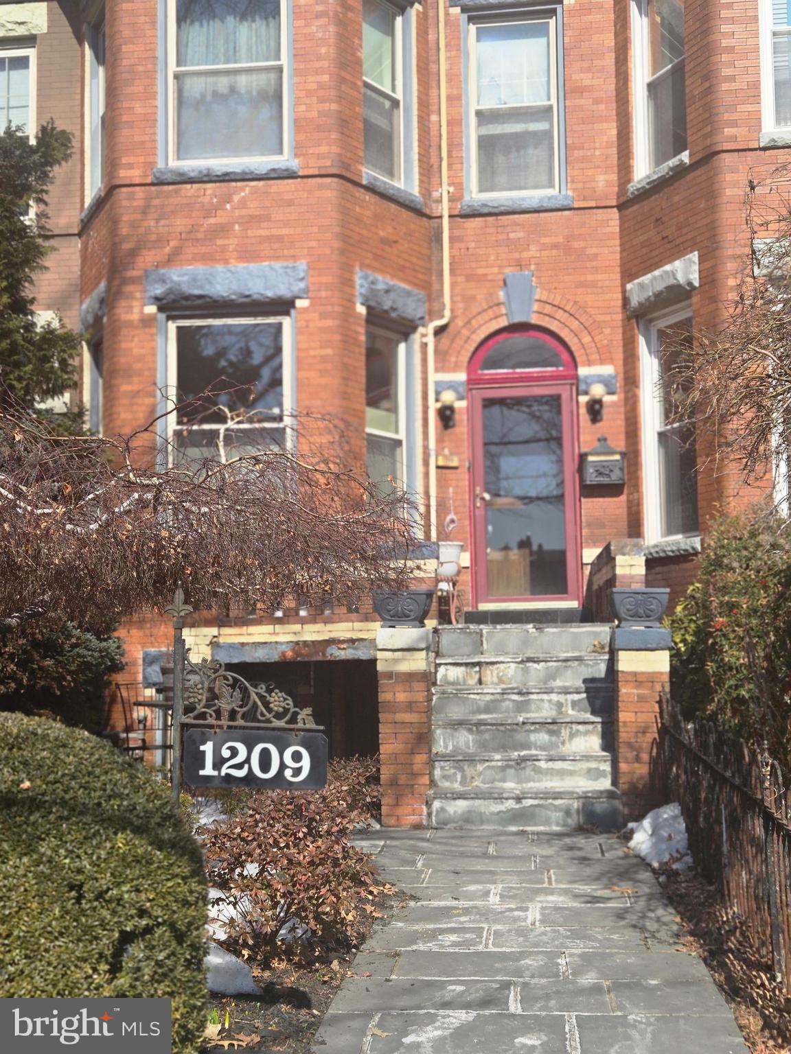 1209 Harvard Street Northwest Washington, DC 20009 - Photo 2 of 9 a view of a brick building with many windows