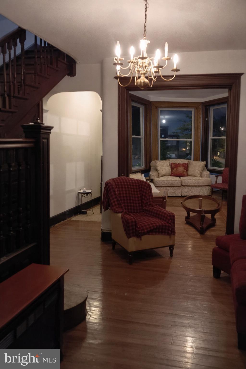 1209 Harvard Street Northwest Washington, DC 20009 - Photo 4 of 9 a living room with furniture and a chandelier