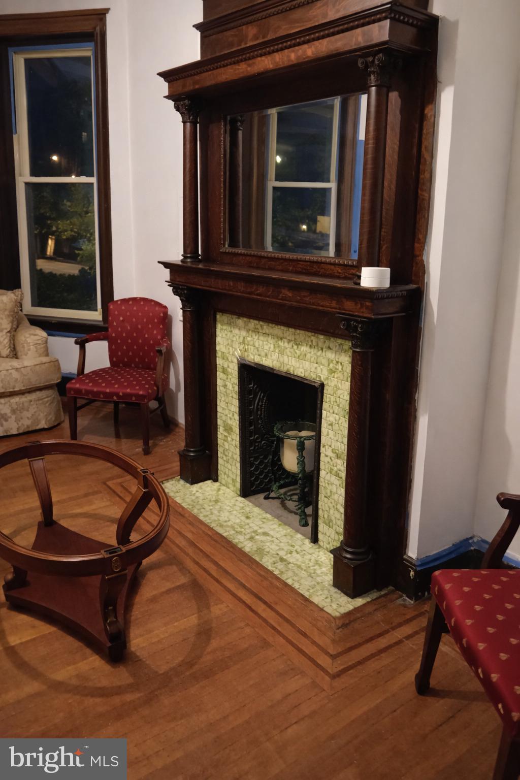 1209 Harvard Street Northwest Washington, DC 20009 - Photo 6 of 9 a living room with furniture and a fireplace