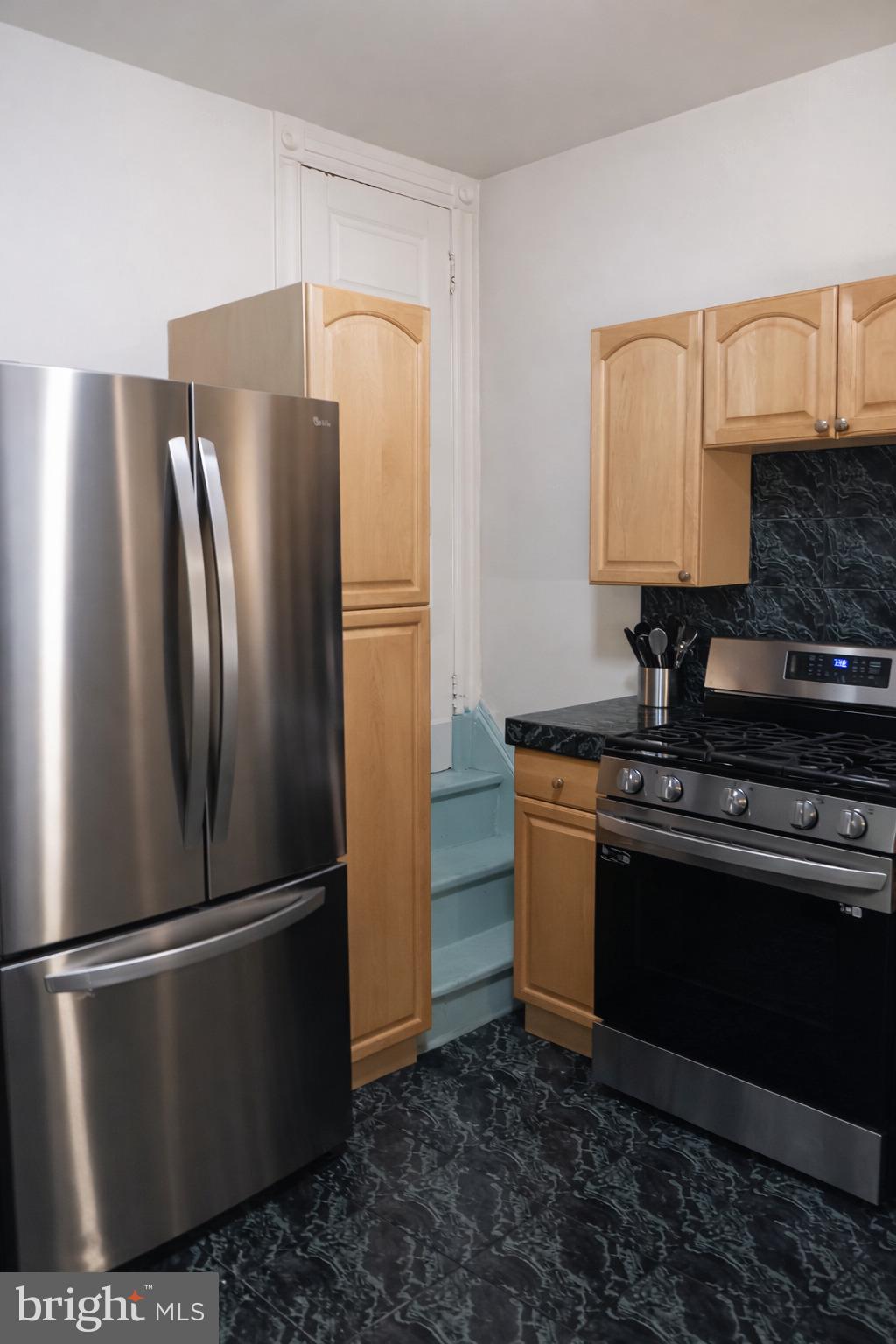1209 Harvard Street Northwest Washington, DC 20009 - Photo 7 of 9 a metallic refrigerator freezer sitting in a kitchen