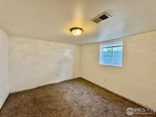 an empty room with a empty space and a window