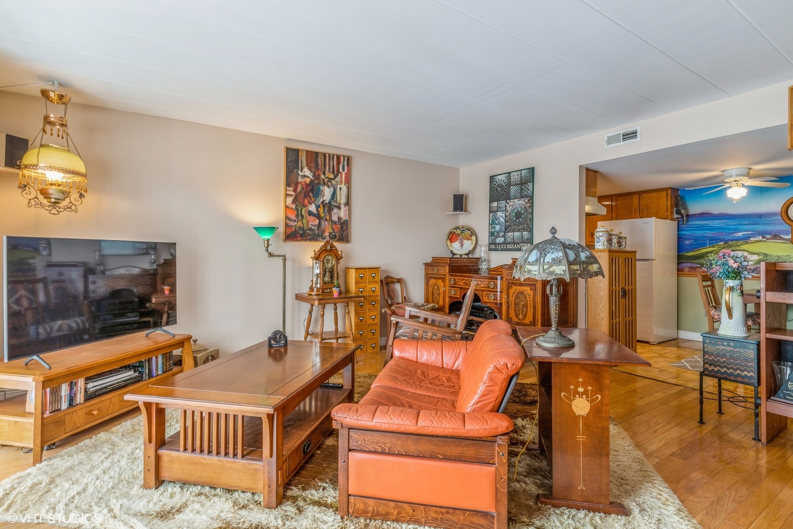 127 North Wolf Road, Unit 54B Wheeling, IL 60090 - Photo 3 of 10 a livingroom with furniture and a flat screen tv