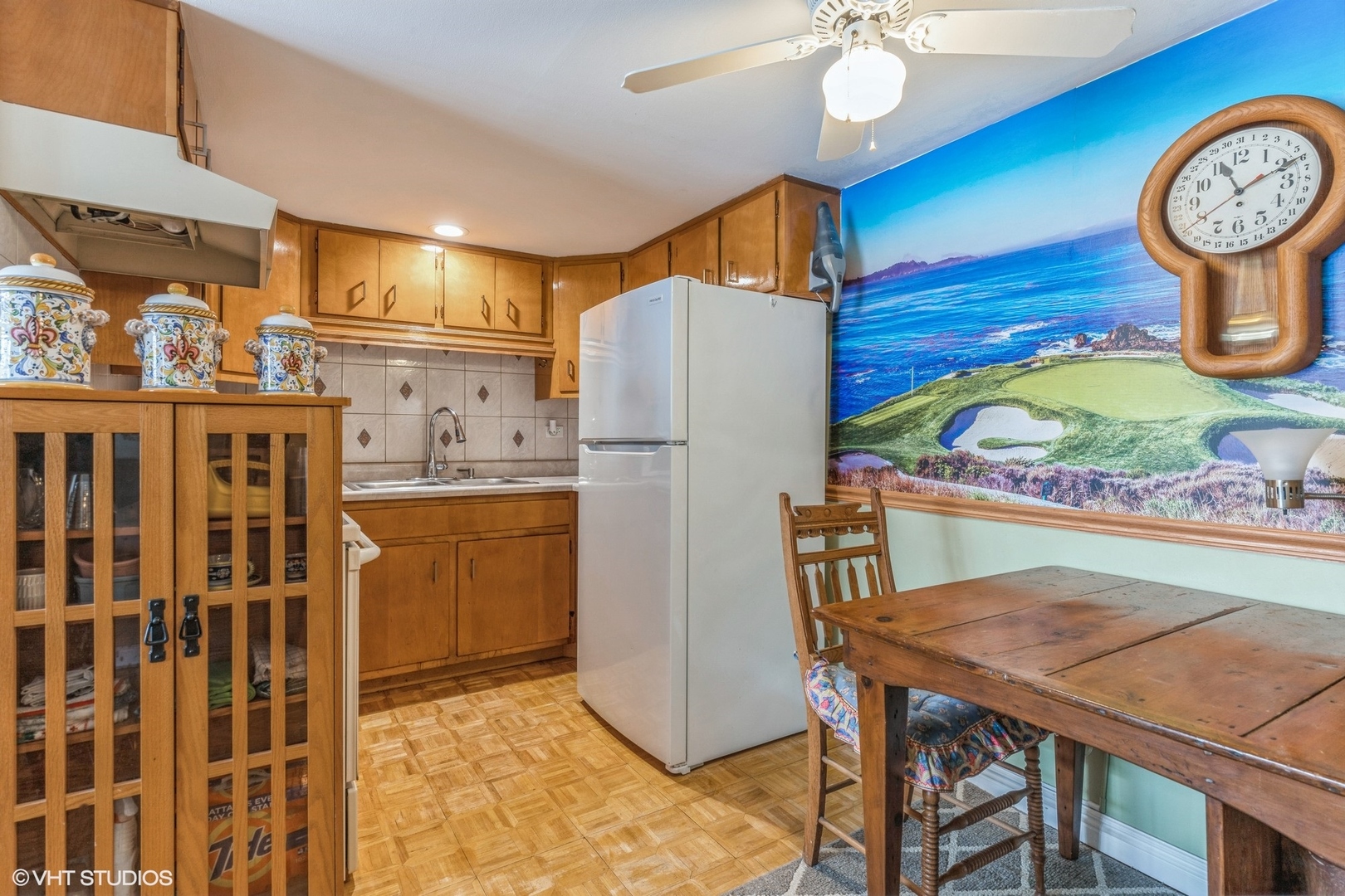 127 North Wolf Road, Unit 54B Wheeling, IL 60090 - Photo 6 of 10 a kitchen with a refrigerator a stove a sink and a dining table with wooden floor