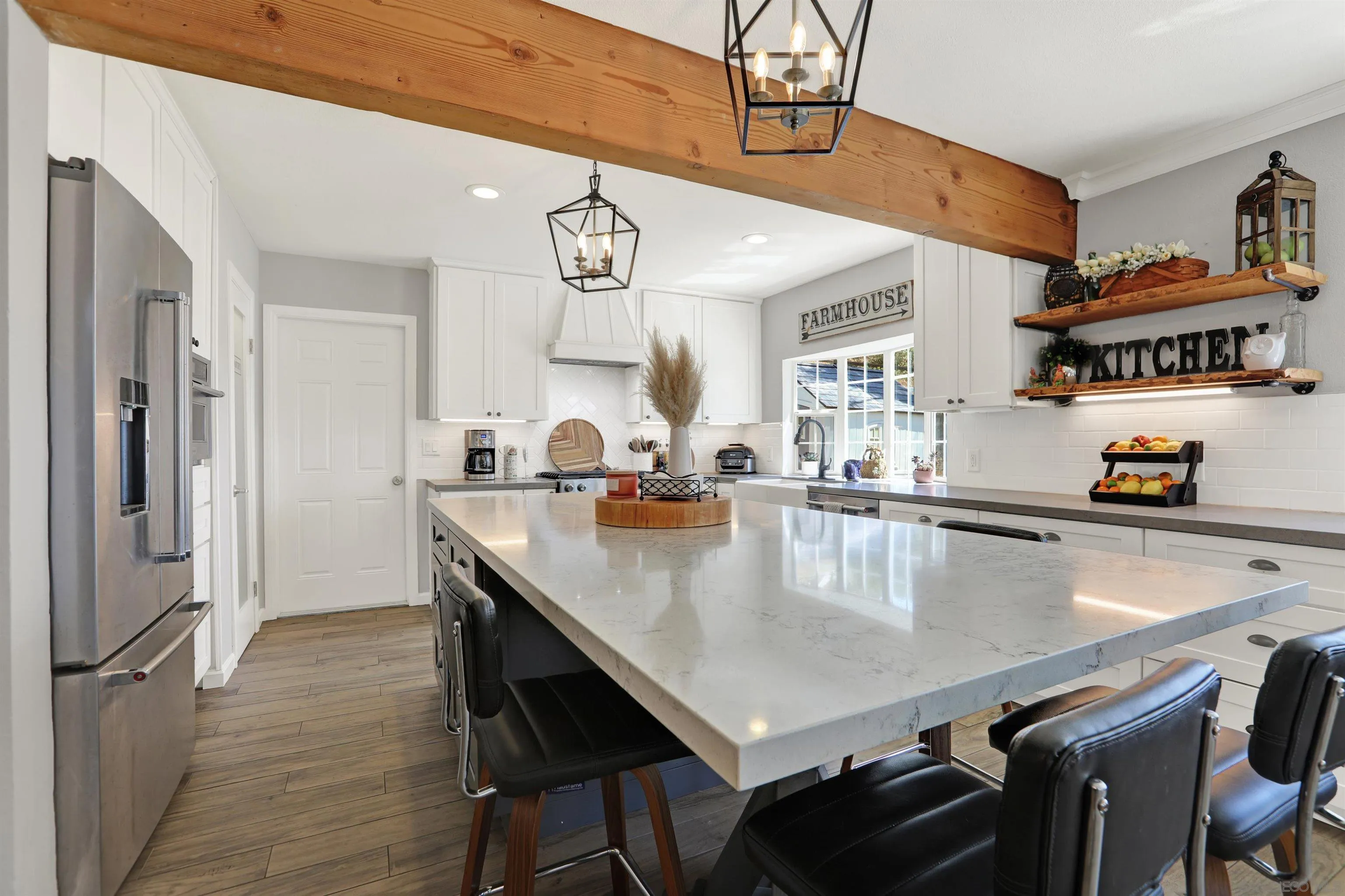 12913 Evalyn Court Poway, CA 92064 - Photo 11 of 56 a kitchen with a table chairs and refrigerator