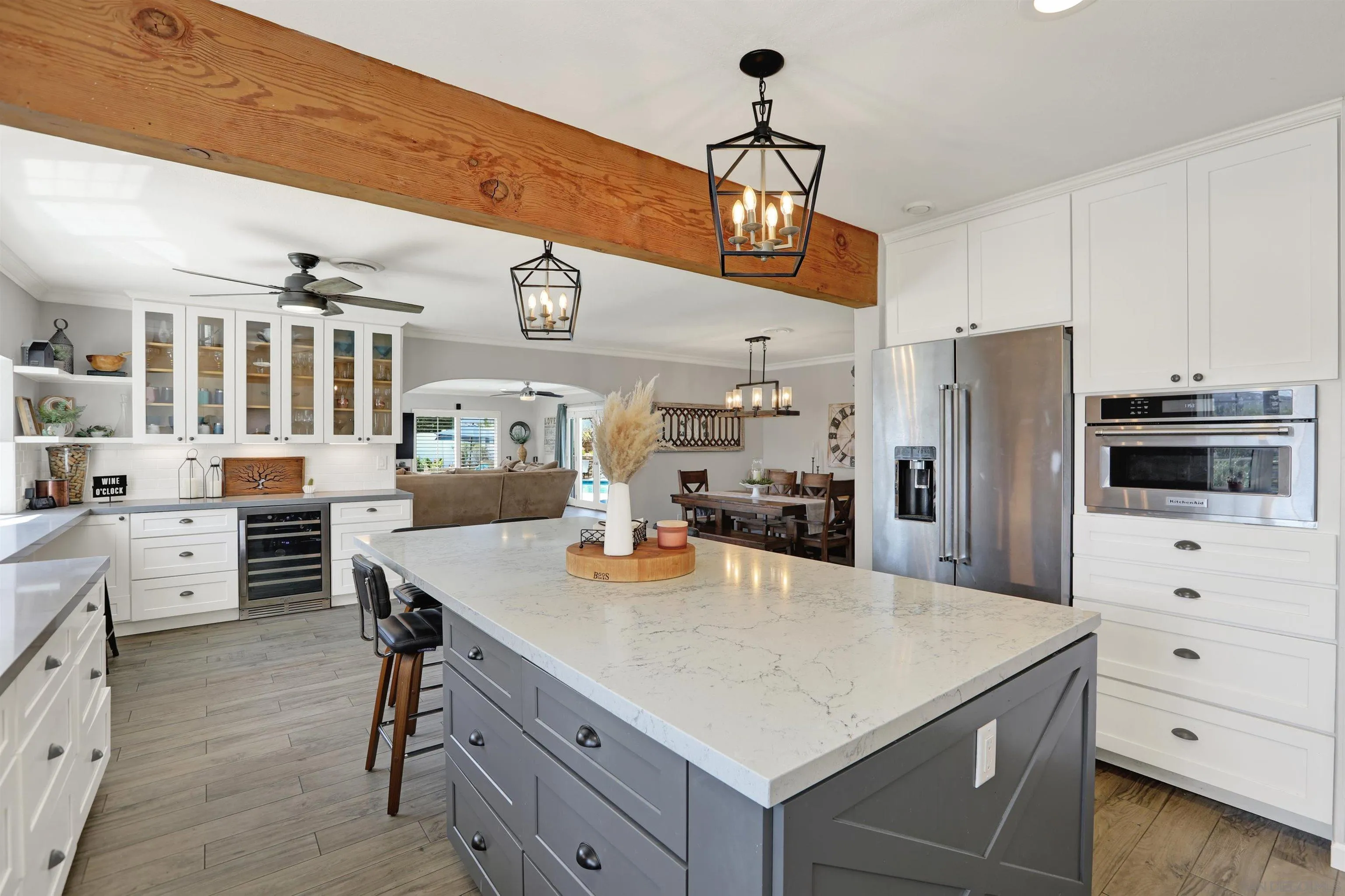 12913 Evalyn Court Poway, CA 92064 - Photo 15 of 56 a kitchen with a table chairs refrigerator and cabinets