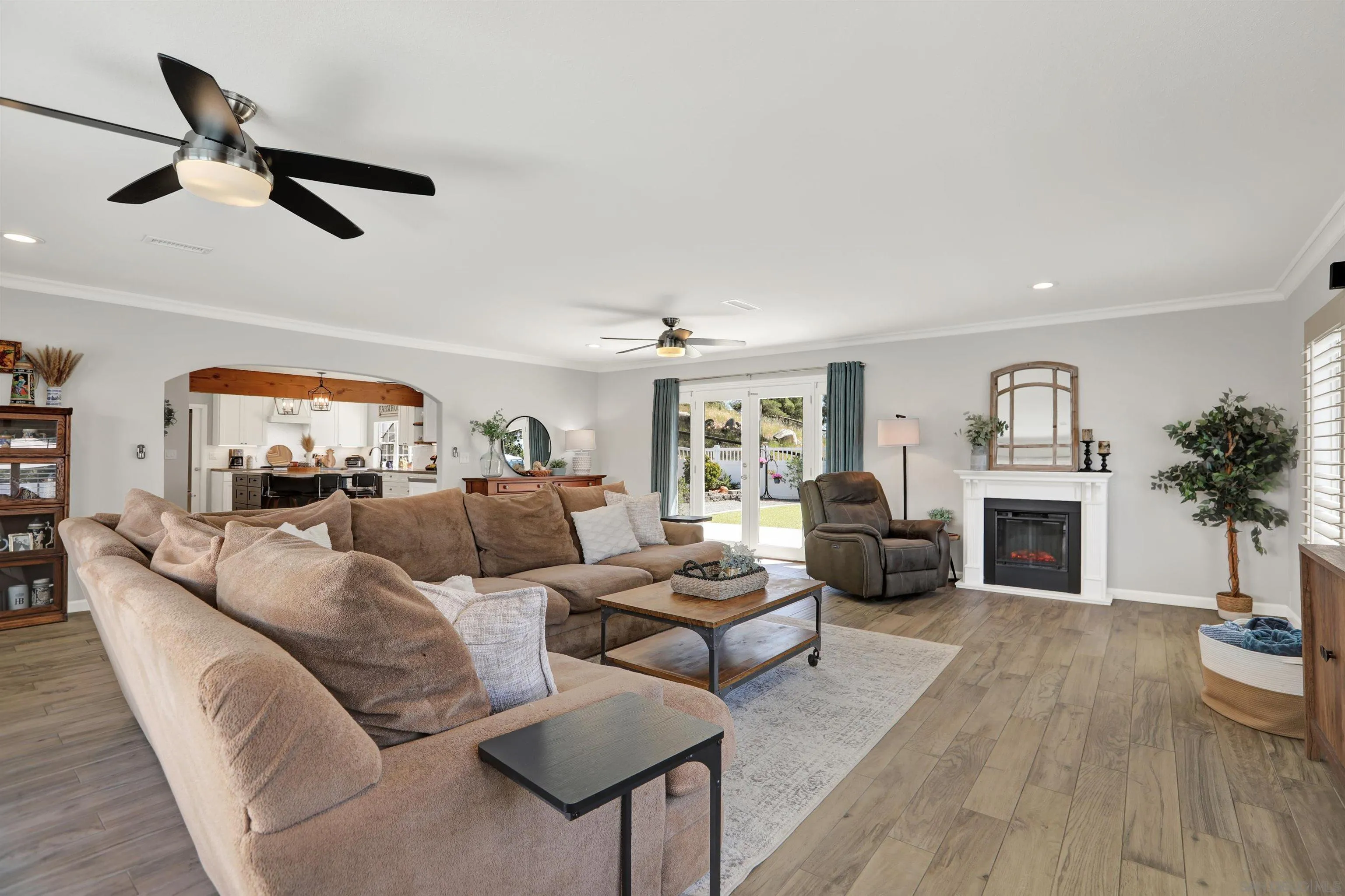 12913 Evalyn Court Poway, CA 92064 - Photo 20 of 56 a living room with furniture a fireplace and a potted plant
