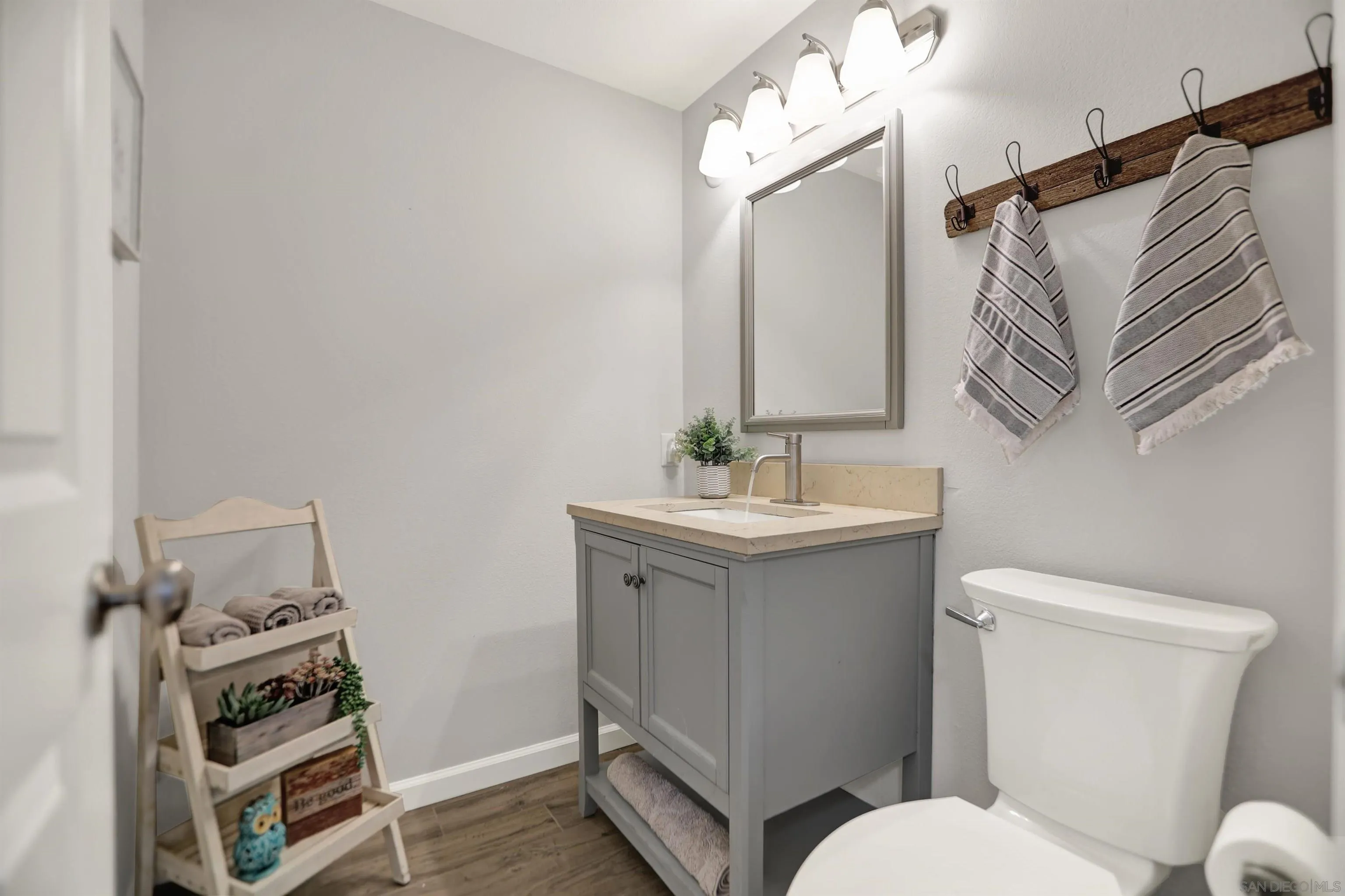 12913 Evalyn Court Poway, CA 92064 - Photo 21 of 56 a white toilet sitting next to a bathroom sink