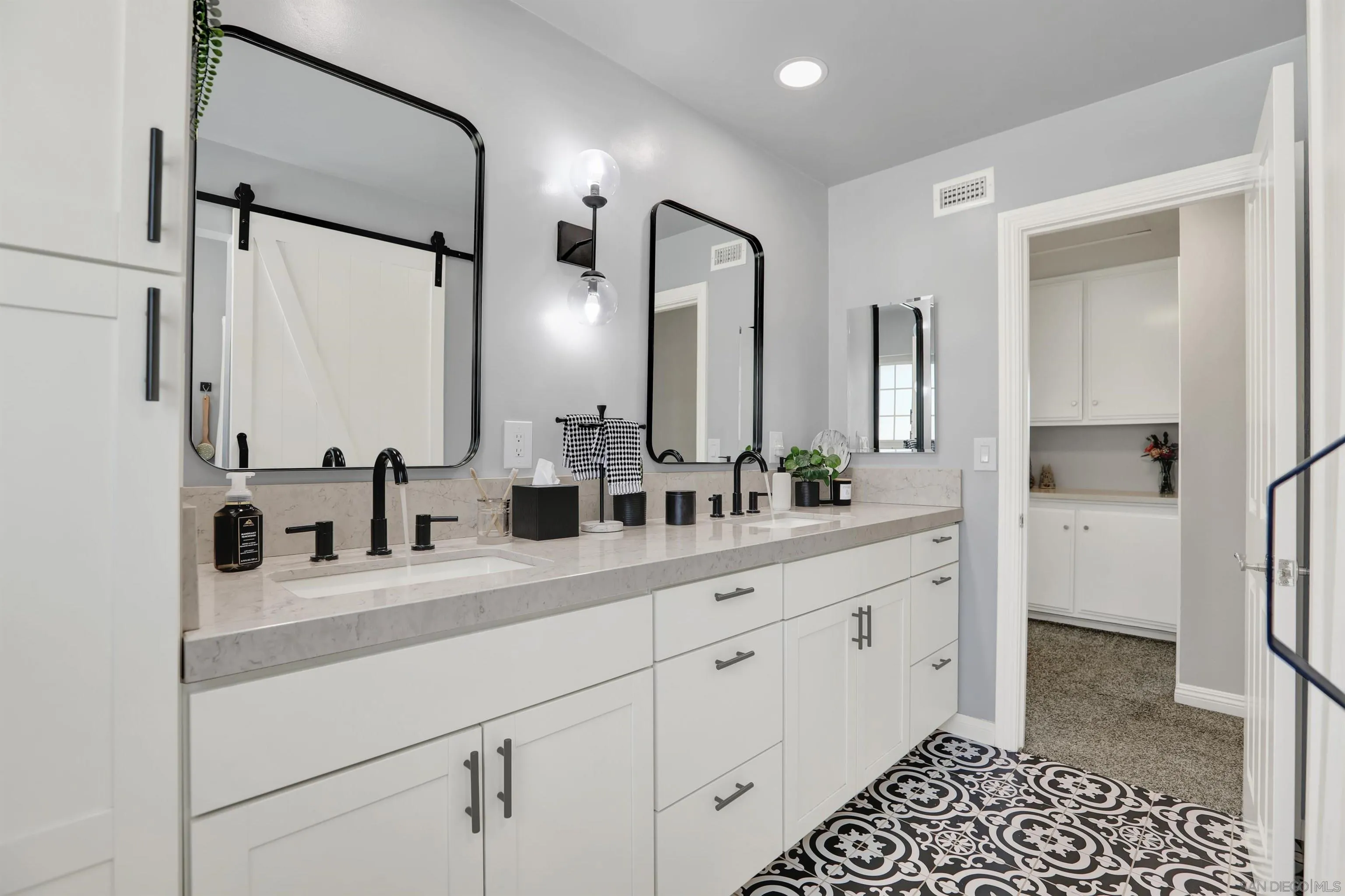 12913 Evalyn Court Poway, CA 92064 - Photo 34 of 56 a bathroom with a double vanity sink mirror and shower