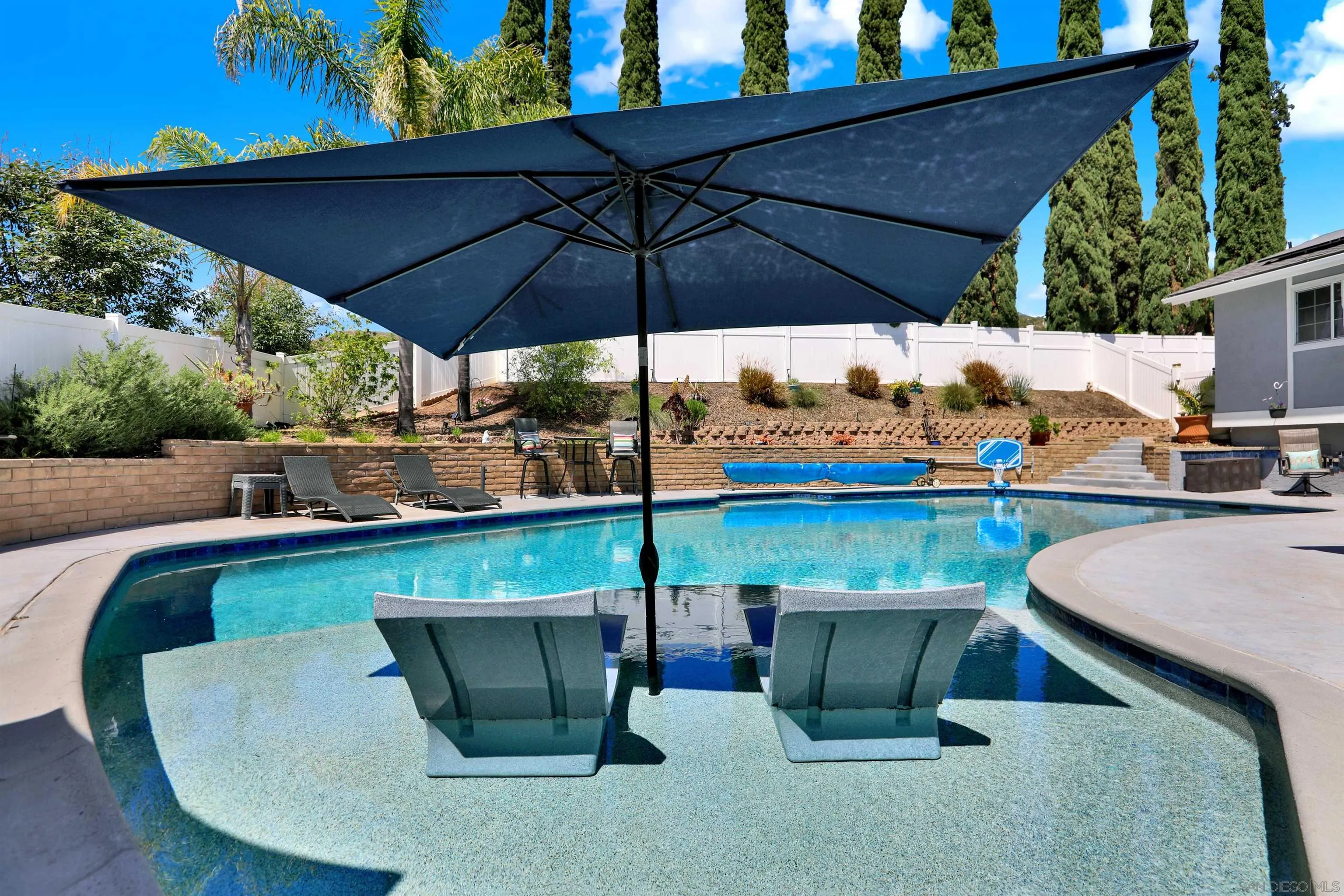 12913 Evalyn Court Poway, CA 92064 - Photo 40 of 56 an outdoor sitting area with furniture and umbrella