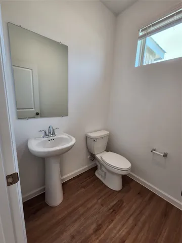 a bathroom with a sink toilet and a mirror