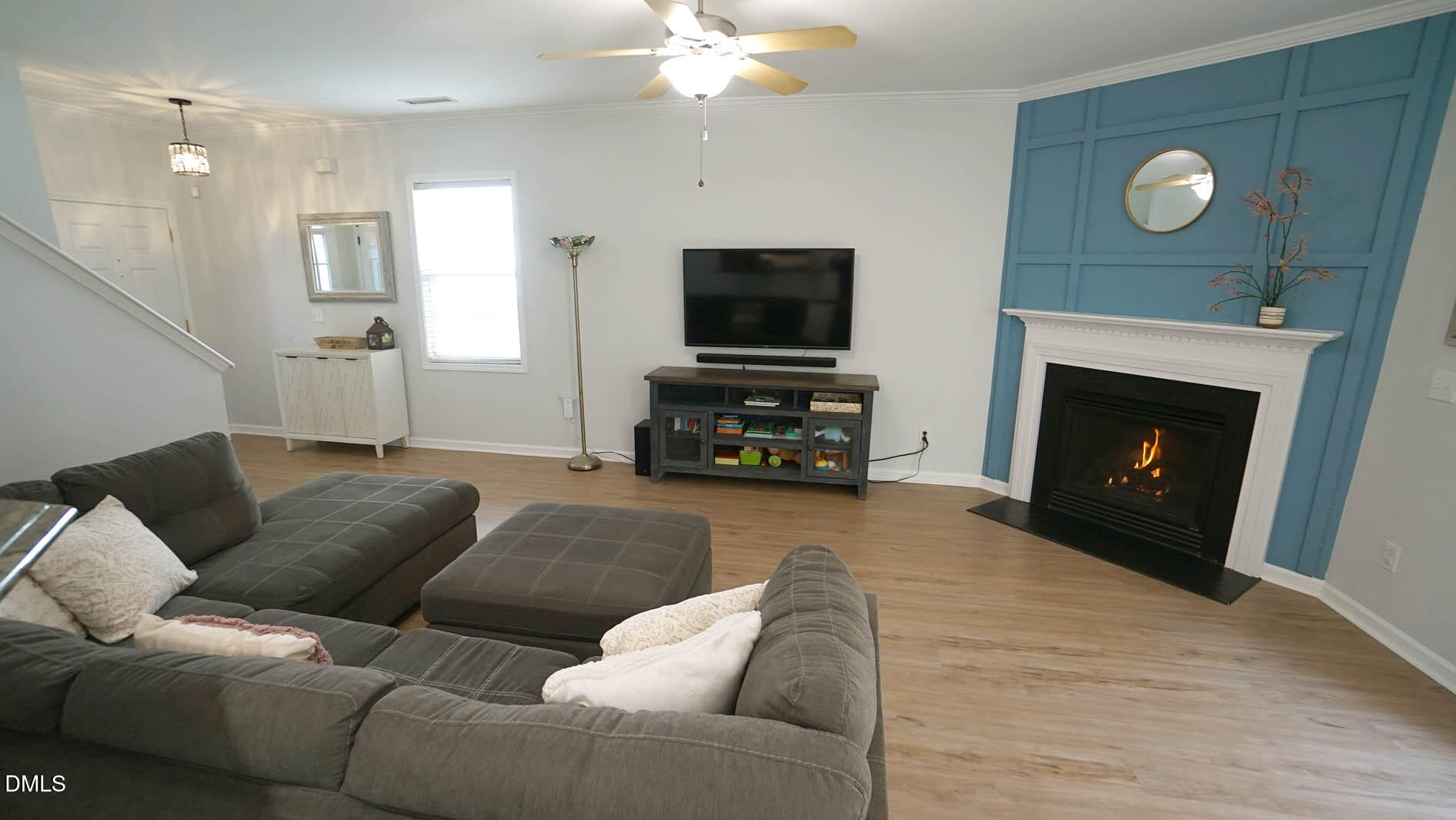311 Inkster Cove Raleigh, NC 27603 - Photo 15 of 39 a living room with furniture a fireplace and a flat screen tv