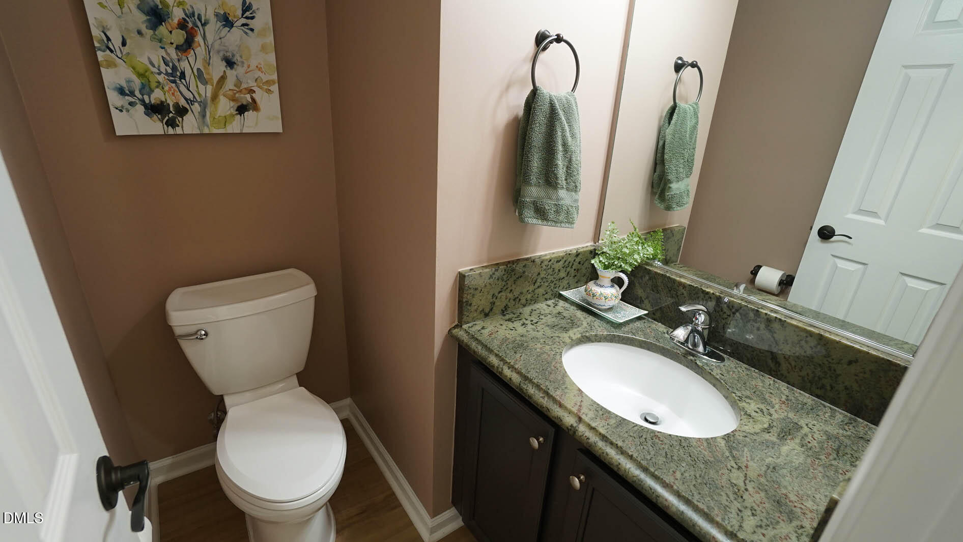 311 Inkster Cove Raleigh, NC 27603 - Photo 16 of 39 a bathroom with a granite countertop toilet sink and mirror