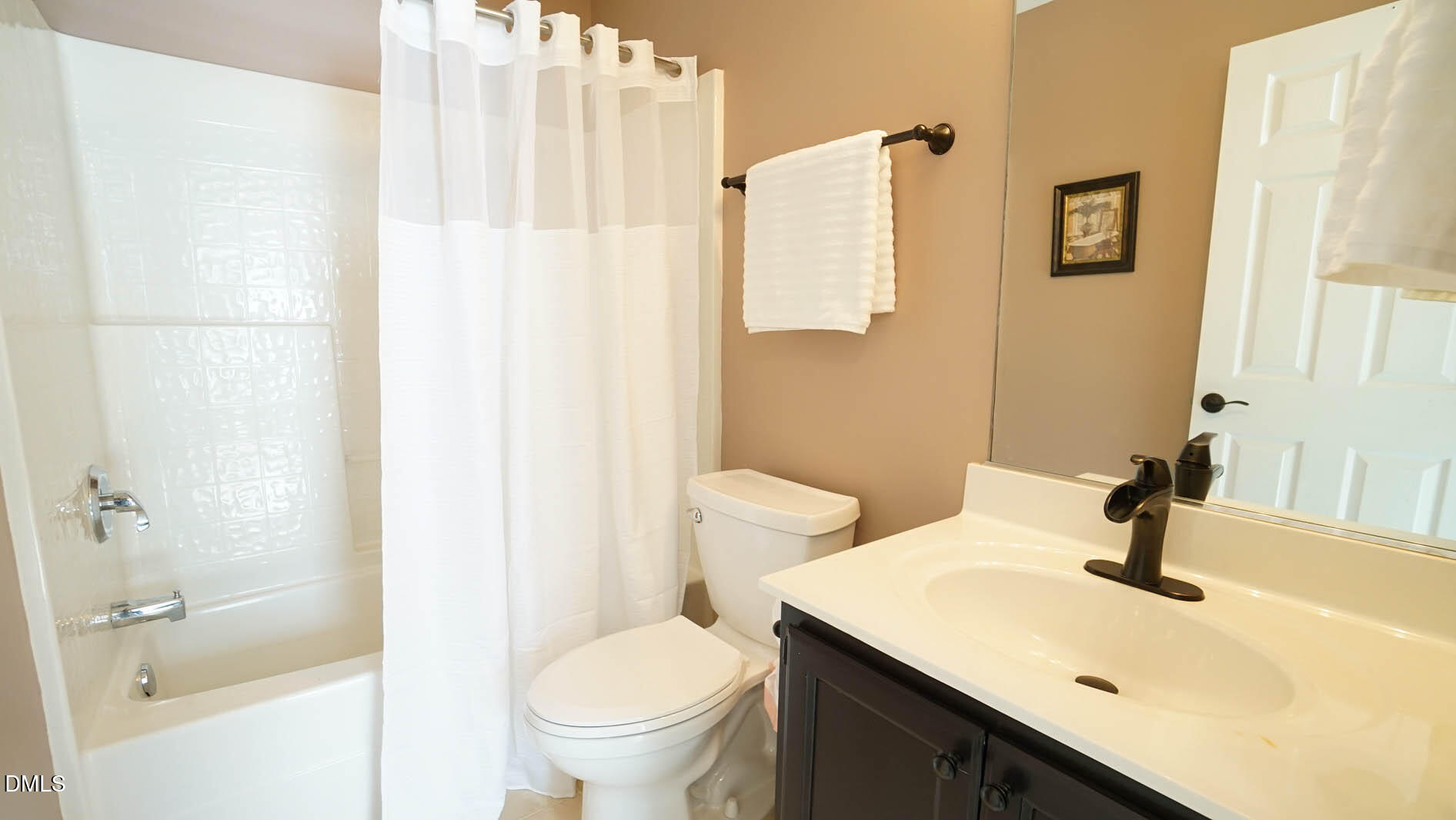 311 Inkster Cove Raleigh, NC 27603 - Photo 26 of 39 a bathroom with a sink a toilet and shower