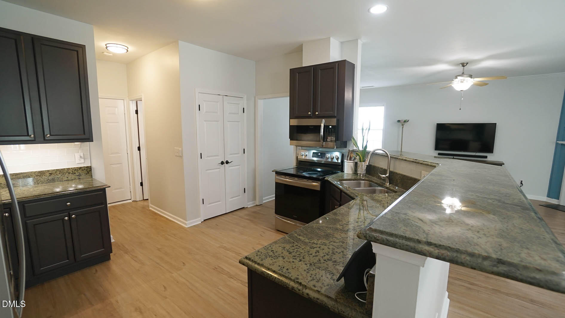 311 Inkster Cove Raleigh, NC 27603 - Photo 8 of 39 a kitchen with stainless steel appliances granite countertop a stove refrigerator and microwave