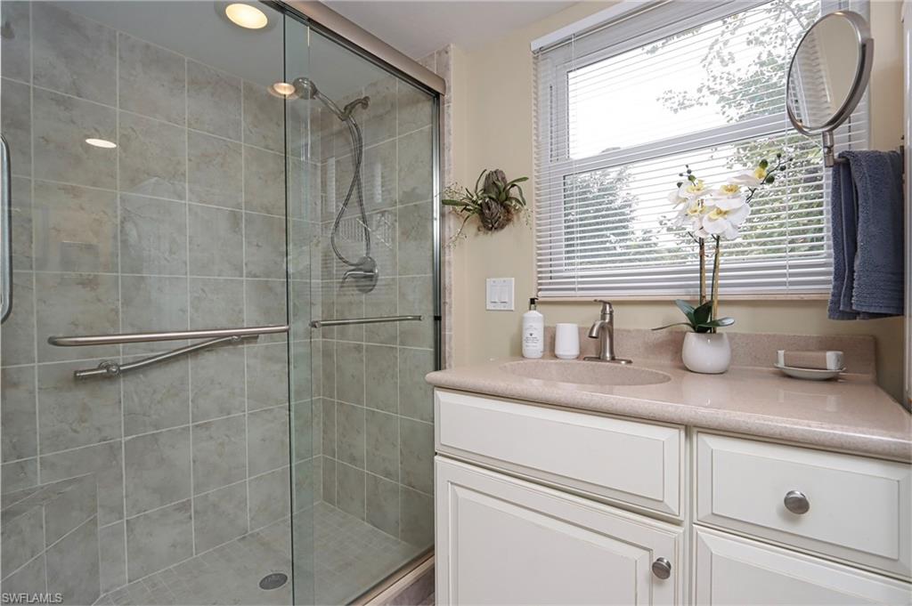 940 3rd Street South, Unit 101 Naples, FL 34102 - Photo 19 of 20 Bathroom featuring a shower stall and vanity