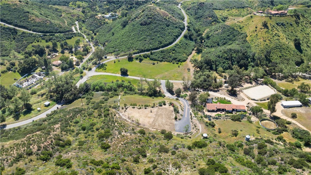 32067 Lobo Canyon Road Agoura Hills, CA 91301 - Photo 2 of 13 an aerial view of a house with a yard and lake view