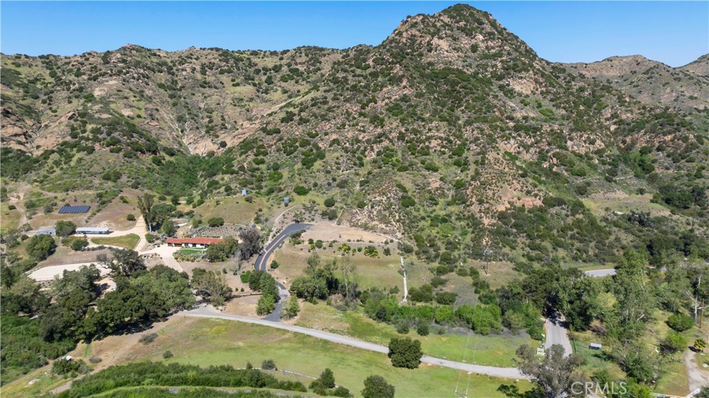 32067 Lobo Canyon Road Agoura Hills, CA 91301 - Photo 7 of 13 a view of a field with a tree in the background