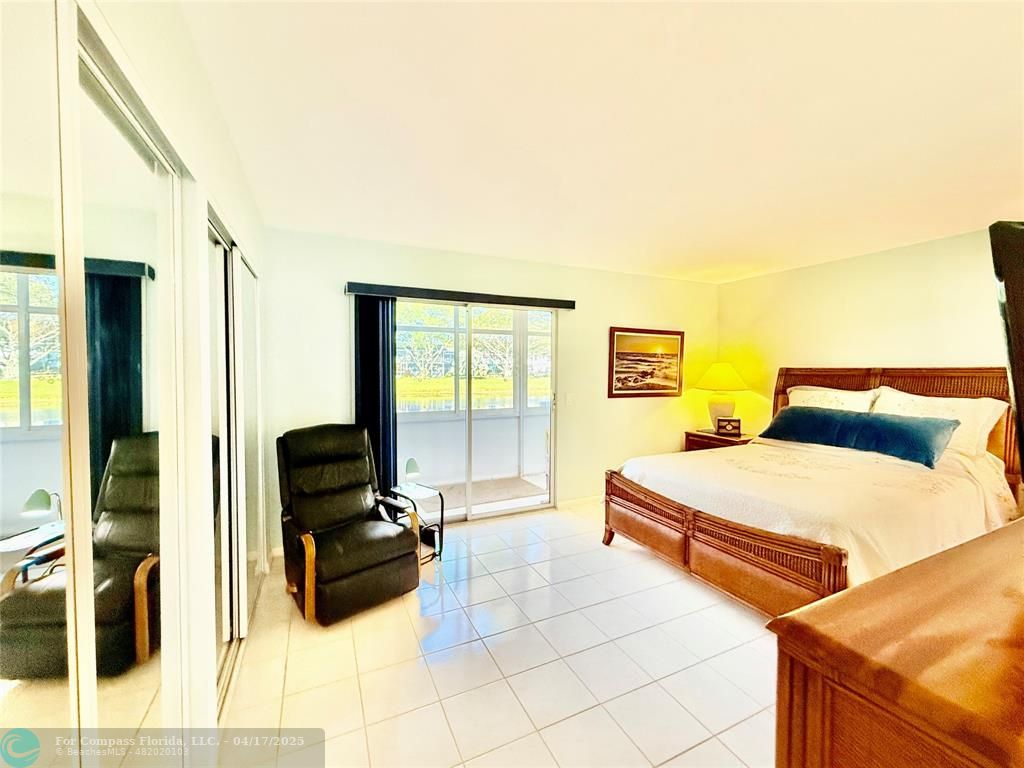 42 Tilford C, Unit 42 Deerfield Beach, FL 33442 - Photo 13 of 50 a bedroom with a bed and a cabinets