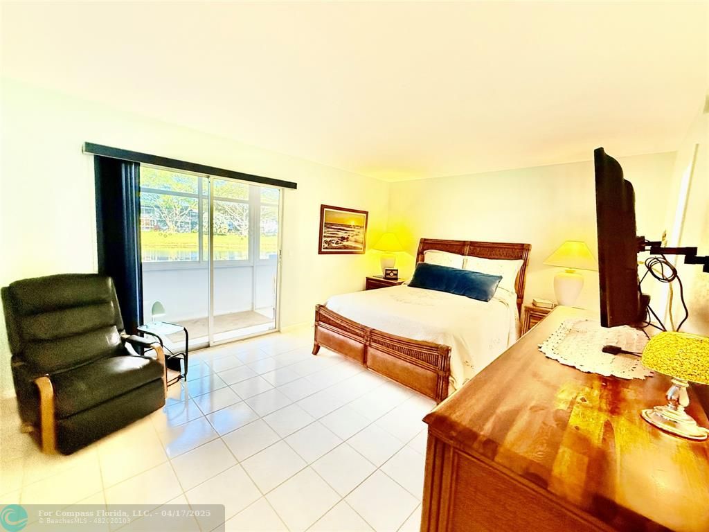 42 Tilford C, Unit 42 Deerfield Beach, FL 33442 - Photo 14 of 50 a bedroom with furniture and large windows